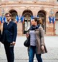 Family leaving polling place French city flags