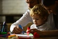 Family leisure, happy mother, father and little child. Happy loving family drawing at home. Children day. Royalty Free Stock Photo