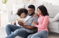 Family Leisure. Man Reading Book With His Wife And Daughter At Home Royalty Free Stock Photo