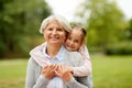 Granddaughter hugging grandmother at summer park Royalty Free Stock Photo