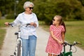 Grandmother and granddaughter with bicycles Royalty Free Stock Photo