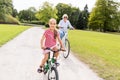 Grandmother and granddaughter cycling at park Royalty Free Stock Photo