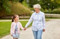 Grandmother and granddaughter walking at park Royalty Free Stock Photo