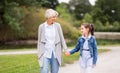 Grandmother and granddaughter walking at park Royalty Free Stock Photo