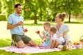 Happy family having picnic at summer park