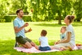 Happy family having picnic at summer park