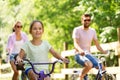 Happy family riding bicycles in summer park Royalty Free Stock Photo