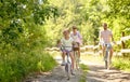 Happy family riding bicycles in summer park Royalty Free Stock Photo