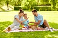 Happy family having picnic at summer park Royalty Free Stock Photo