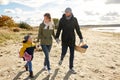 Happy family going to picnic on beach in autumn Royalty Free Stock Photo