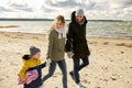 Happy family going to picnic on beach in autumn Royalty Free Stock Photo