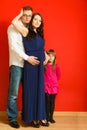 Pregnant woman, man and daughter posing Royalty Free Stock Photo