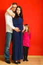 Pregnant woman, man and daughter posing Royalty Free Stock Photo