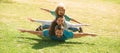 Family leisure time. Family lying on grass in park. Parents giving child piggybacks in park. Royalty Free Stock Photo