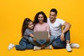 Family Leisure. Young middle eastern parents and little daughter using laptop together Royalty Free Stock Photo