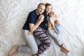 The family lies in bed on a white bed Royalty Free Stock Photo