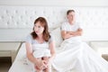 Family life concept.Problems in relationships. Middle age couple in bedroom. Man and woman in bed. Quarrel and upset emotions. Royalty Free Stock Photo