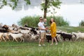 Family life. Portrait of parents and their son against the background of passing goats. Walk in park. Happy family leisure Royalty Free Stock Photo