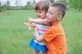 Family lifestyle. big brother watching over little sister. kids playing outdoor in the park having fun. boy hug little girl. Royalty Free Stock Photo