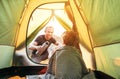 Family lisure concept image. Father and son prepare for camping in mountain, drink tea in ten