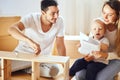 Family reading instruction and assemble furniture together at living room of new apartment pile of moving boxes on Royalty Free Stock Photo