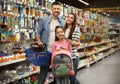 Family with little girl at section with school stationery