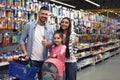 Family with little girl at section with school stationery