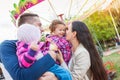 Family with little girls enjoying time at fun fair Royalty Free Stock Photo