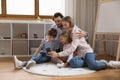 Family with little kids use smart phone at home Royalty Free Stock Photo