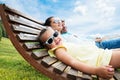 Family With Little Relaxing In Sun Lounger