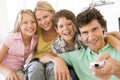 Family in living room with remote control Royalty Free Stock Photo