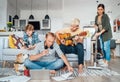 Family at living room together on Quarantine time.Father distance working using laptop, mother cleaning the room, older son Royalty Free Stock Photo