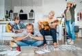 Family at living room together on Quarantine time.Father distance working using laptop, mother cleaning the room, older son Royalty Free Stock Photo