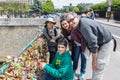 Family locking love padlock at Seine bridge in Paris, France Royalty Free Stock Photo