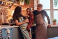 Family in loft style kitchen at morning. Mother hold on hands her cute daughter.