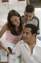 Family looking at cell phone Royalty Free Stock Photo