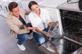Family looking at dishwashers in domestic appliances shop Royalty Free Stock Photo