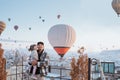 family looking at hot air balloon flying around them in cappadocia