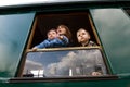 Family looking out of window Royalty Free Stock Photo