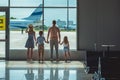 Family looking out window in airport Royalty Free Stock Photo