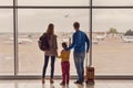 Family looking out window at airport