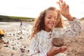 Family Looking In Rockpools On Winter Beach Vacation Royalty Free Stock Photo