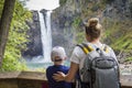 Family looking at a scenic waterfall on a hike together