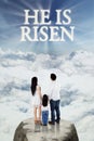 Family looking at text he is risen Royalty Free Stock Photo