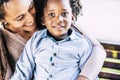 Family love concept with black afro mother and young son children together hugging and smilling with happiness - beautiful couple Royalty Free Stock Photo