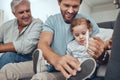 Family, love and dad with child on sofa to tie shoes laces enjoying weekend, quality time and bonding together. Family Royalty Free Stock Photo