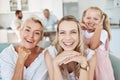 Family, love and generations with a girl, mother and grandmother sitting on a sofa in a living room of their home Royalty Free Stock Photo