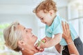 Family, love and grandma play with baby at home bonding, having fun and enjoy quality time together. Grandmother lifting Royalty Free Stock Photo