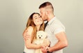 Family love. Guy and girl cuddling. Enjoying each other. Happy family. Valentines day holiday. Soft toy teddy bear gift