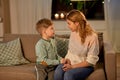 Happy smiling mother talking to her son at home Royalty Free Stock Photo